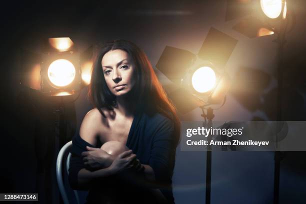 woman at film studio with lighting equipment - actress backstage stock pictures, royalty-free photos & images