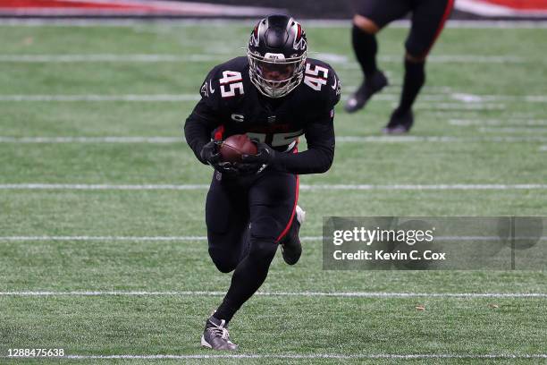 Deion Jones of the Atlanta Falcons runs after intercepting a pass by Derek Carr of the Las Vegas Raiders for a touchdown during their NFL game at...