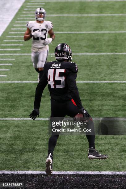 Deion Jones of the Atlanta Falcons scores a touchdown after intercepting a pass by Derek Carr of the Las Vegas Raiders during their NFL game at...