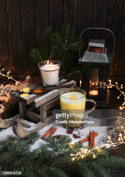 golden milk kurkuma chai in christmas winter background with candle and snow - kurkuma stock pictures, royalty-free photos & images