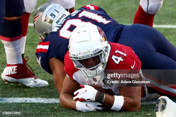 Kenyan Drake of the Arizona Cardinals scores a one yard touchdown against Deatrich Wise of the New England Patriots during the fourth quarter of the...