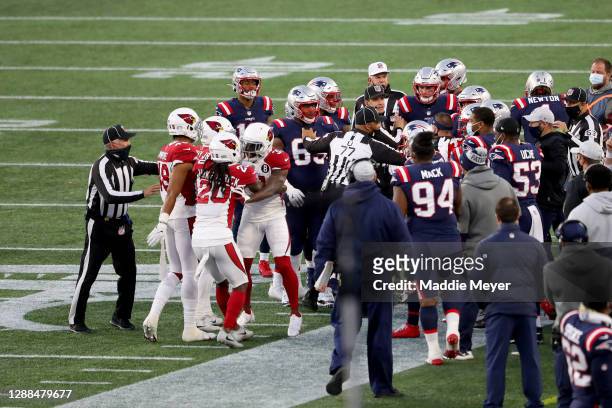 Referee Terry McAulay breaks up a fight between the Arizona Cardinals and the New England Patriots during the fourth quarter of the game at Gillette...
