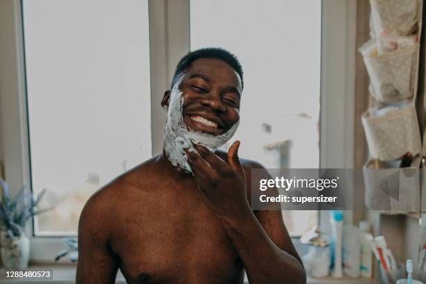 young man doing morning rituals - shaving cream stock pictures, royalty-free photos & images