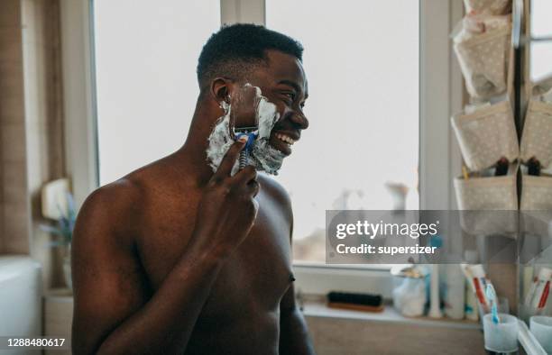 young man doing morning rituals - barbear imagens e fotografias de stock