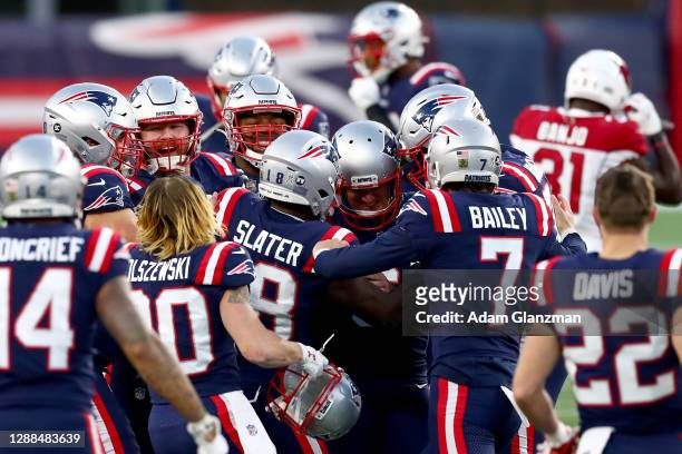 Nick Folk of the New England Patriots celebrates with his teammates after kicking a 50 yard game winning field goal against the Arizona Cardinals...