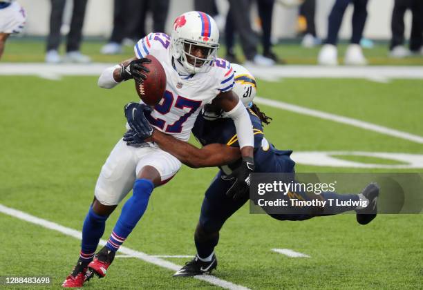 Tre'Davious White of the Buffalo Bills intercepts the ball and is tackled by Mike Williams of the Los Angeles Chargers during the fourth quarter at...