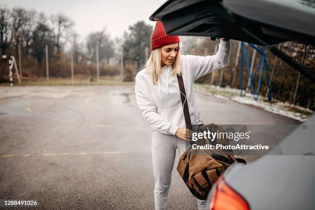 woman getting ready for training - duffle bag stock pictures, royalty-free photos & images