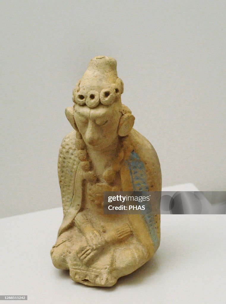 Seated human figure.