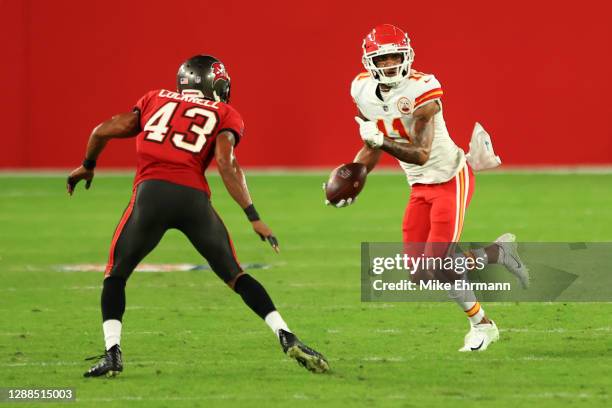 Demarcus Robinson of the Kansas City Chiefs looks to gain extra yardage in the fourth quarter against Ross Cockrell of the Tampa Bay Buccaneers...