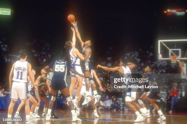 Alonzo Mourning of the Georgetown Hoyas and Christian Laettner of the Duke Blue Devils tips off the ball during ACC/Big Eat Challenge game at USAir...