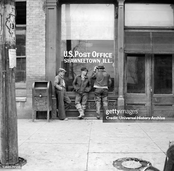 Three Men hanging out in front of U.S. Post Office, Shawneetown, Illinois, USA, Russell Lee, U.S. Office of War Information, April 1937.