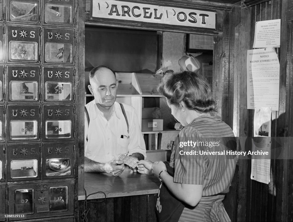 Woman buying Stamps in Post Office, Siren, Wisconsin, USA, John Vachon, U.S. Office of War Information, July 1941