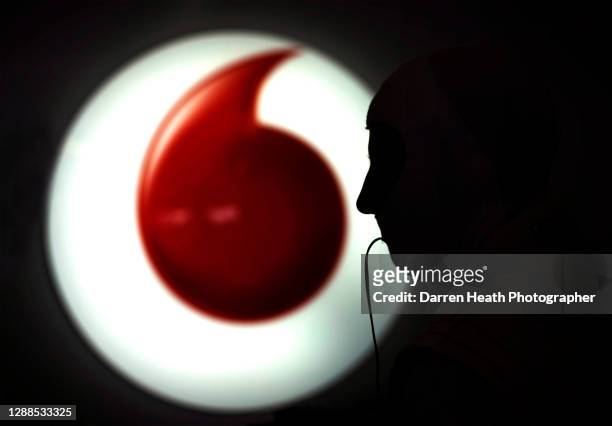 British McLaren Formula One racing driver Jenson Button in the pit garage in front of a Vodafone logo during practice for the 2010 Abu Dhabi Grand...