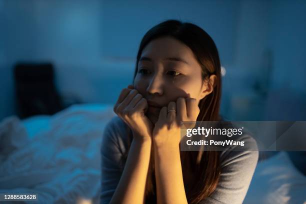 woman feel depress in bedroom - yellow september stock pictures, royalty-free photos & images