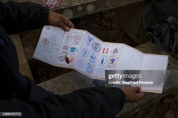 Brazilian pilgrim Victor Bezerra shows a document known as the "pilgrim's passport", which gives access to accommodation and is stamped at each town...