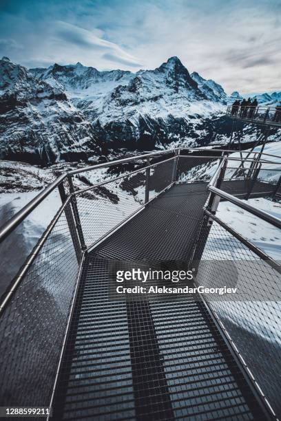 people standing on the end of grindelwald first, switzerland - jungfraujoch stock pictures, royalty-free photos & images