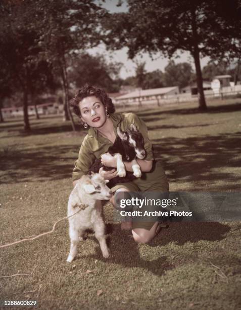 Canadian-American actress Yvonne De Carlo with two goats, USA, circa 1955.