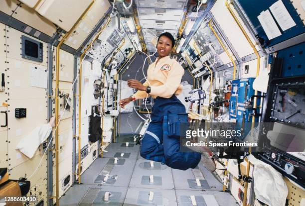 American engineer and astronaut Mae Jemison works in zero gravity in the centre aisle of the Spacelab Japan science module aboard OV-105, the Space...