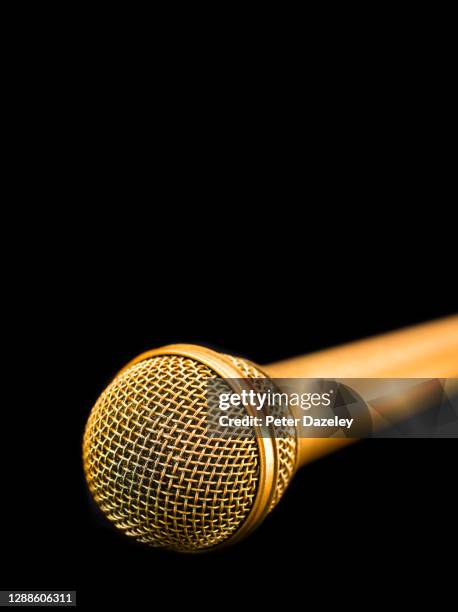 gold microphone on black background - fabolous in concert stock pictures, royalty-free photos & images