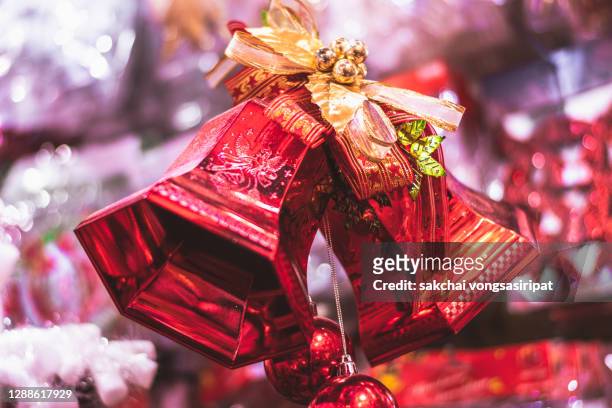 red christmas bells decoration on christmas tree - christmas bells stock pictures, royalty-free photos & images