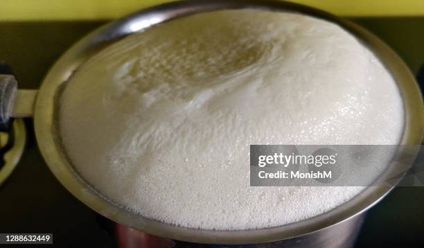 boiling milk - boiled stockfoto's en -beelden