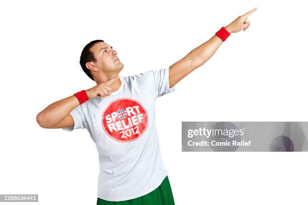 Paddy McGuiness does the Usain Bolt pose in the studio whilst wearing a sport relief t-shirt and sweatbands for sport relief 2012 in London,...