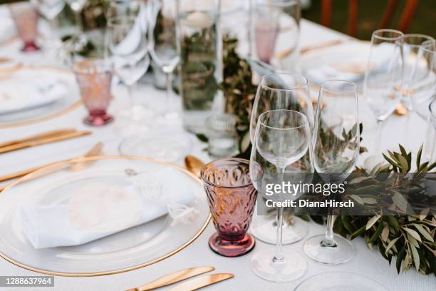 beautiful boho wedding table decoration with olive branches and rose drink glasses in majorca - wedding reception stock pictures, royalty-free photos & images