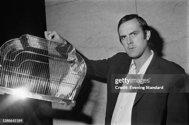 English comedian and actor John Cleese with a dead parrot soft toy, in reference to the famous Monty Python sketch, UK, 1971.