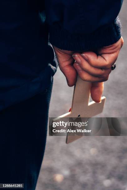 person holding a small wooden cross - armistice stock pictures, royalty-free photos & images