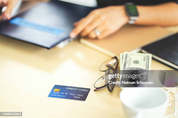 credit card, dollar, eyeglasses, cup of coffee on desk of businessman. - credit card mockup stock-fotos und bilder