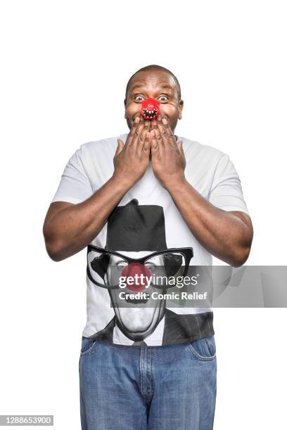 British stand-up comedian, actor, singer, writer and television presenter Lenny Henry, wearing a Red Nose Day 2013 nose and t-shirt, in the studio on...