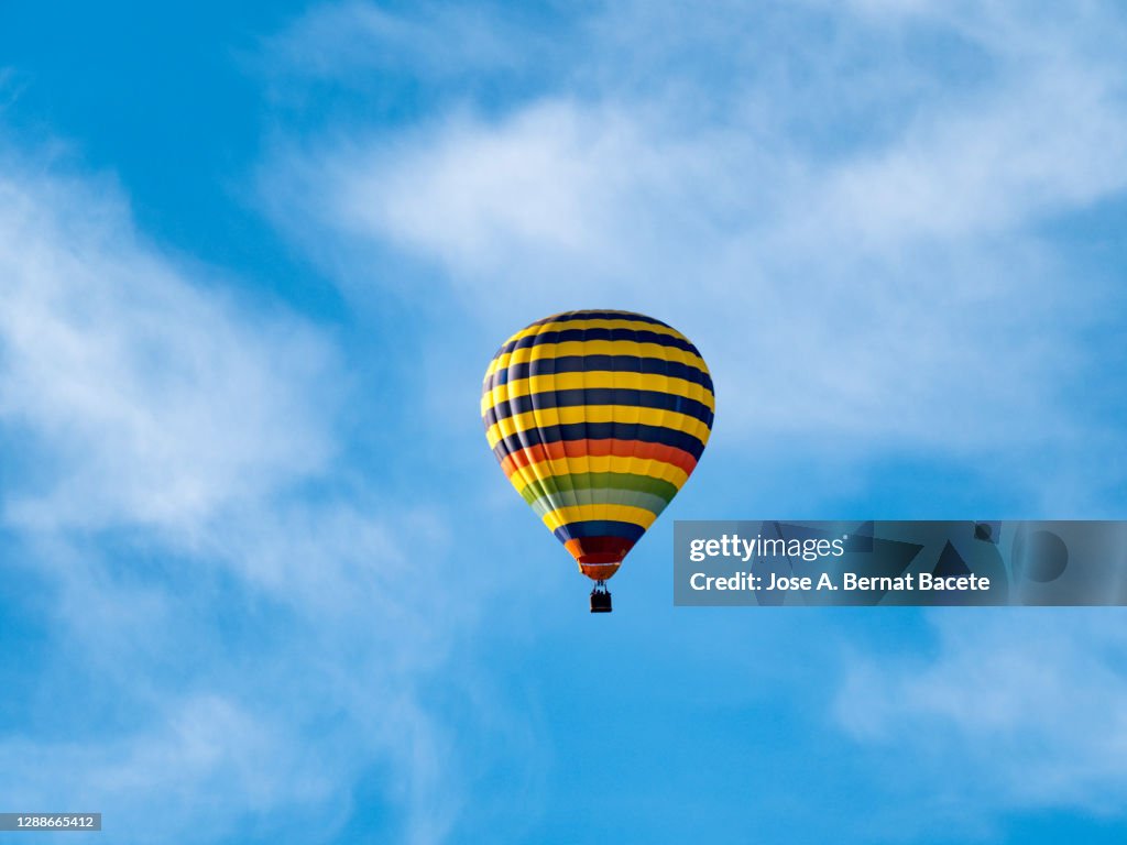 A hot air balloon flying on the blue sky.