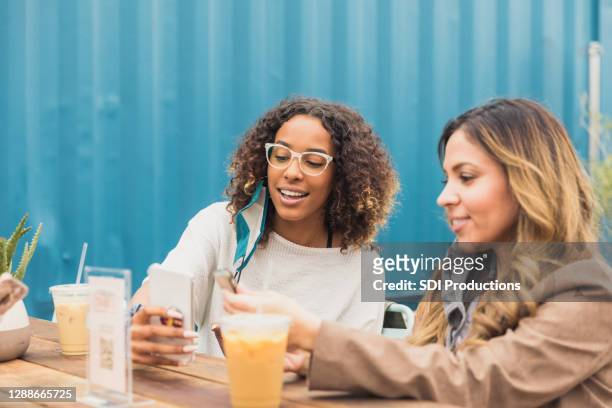 women download menu in restaurant during covid-19 - restaurant covid stock pictures, royalty-free photos & images