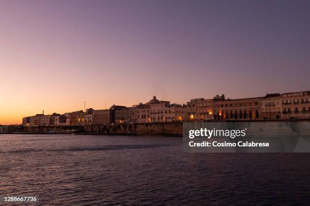 taranto: view of the old town from the sea at sunset - taranto stock-fotos und bilder