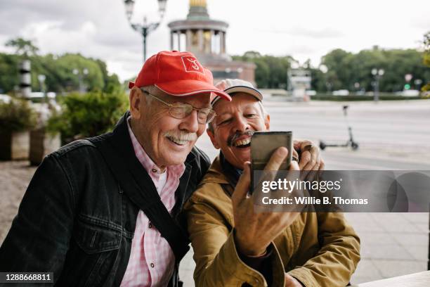 mature gay couple taking selfie together - telephone call holiday stock pictures, royalty-free photos & images