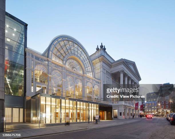 Glass pavilion below Floral Hall viewed at dusk from Bow Street. Royal Opera House, London, United Kingdom. Architect: Stanton Williams, 2018.