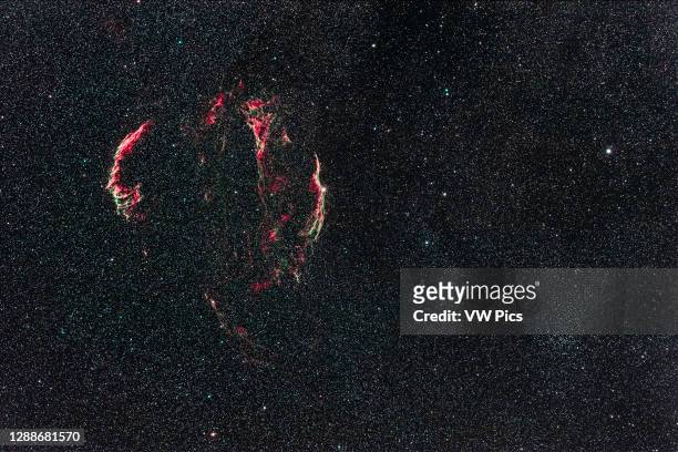 The supernova remnant in Cygnus variously called the Veil Nebula, the Network Nebula, the Lacework Nebula, or the Cygnus Loop. Nearby is the bright...