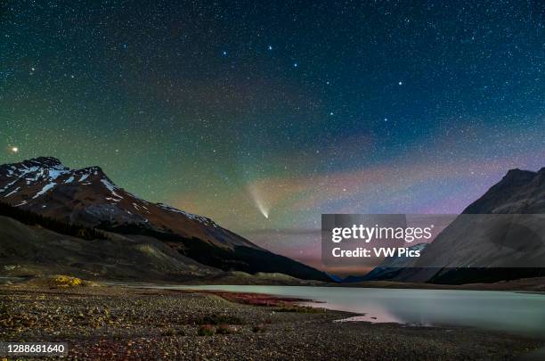 Comet NEOWISE on July 27, 2020 from the Columbia Icefields from the Toe of the Glacier parking lot, looking north over Sunwapta Lake, formed by the...