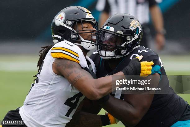 Bud Dupree of the Pittsburgh Steelers in action against Cam Robinson of the Jacksonville Jaguars at TIAA Bank Field on November 22, 2020 in...