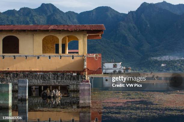 Flooded houses in the town of San Pedro la Laguna, Guatemala. Since 2009 Lake Atitlan in Guatemala has risen more than 30 feet, flooding farmlands...