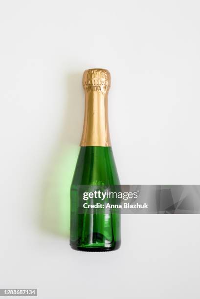 green glass bottle of champagne over white background. new year greeting card. - champagne cork stock pictures, royalty-free photos & images