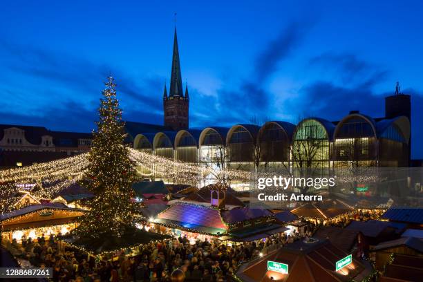 Huge decorated Christmas tree during Xmas fair on the market place in front of town hall in Lubeck / Luebeck, Schleswig-Holstein, Germany.