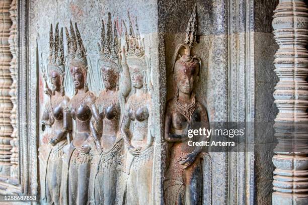 Relief sculpture of apsaras / devatas at Angkor Wat, temple complex dedicated to the god Vishnu for the Khmer Empire, Siem Reap, Cambodia.