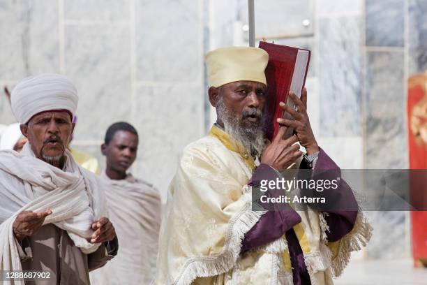 Orthodox priest holding bible at the Church of Our Lady Mary of Zion, Axum / Aksum, Tigray Region, Ethiopia, Africa.