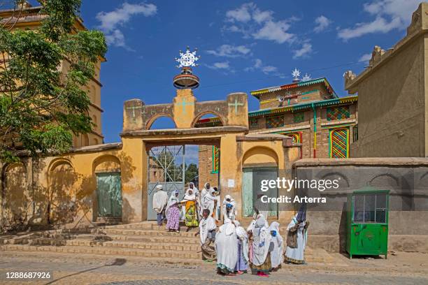 Churchgoers dressed in white leaving the Arabtu Ensessa Church / Arbatu Ensessa Church in town Axum / Aksum, Maekelay Zone, Tigray Region, Ethiopia.