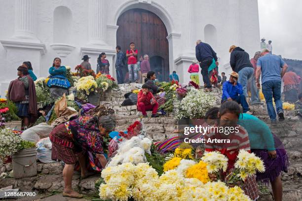 Local people called Mayan K'iche selling flowers on market day in front of the church Iglesia de Santo Tomas in Chichicastenango, El Quiche,...