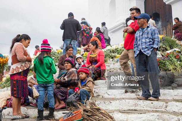 Local people called Mayan K'iche selling flowers on market day in front of the church Iglesia de Santo Tomas in Chichicastenango, El Quiche,...