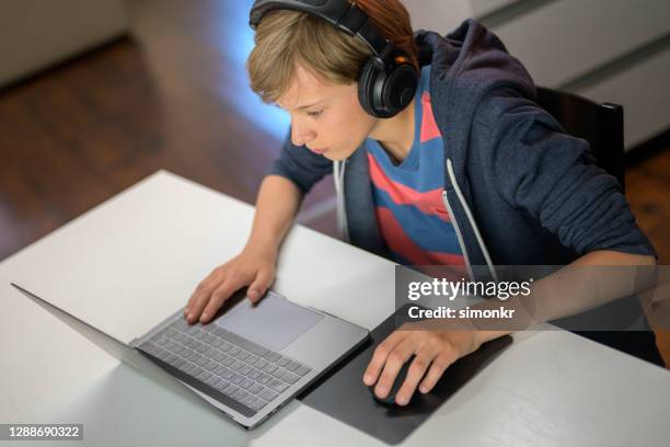 boy attending online school classes from home - mouse pad stock pictures, royalty-free photos & images