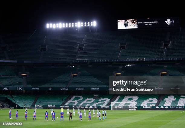 Players and Officials observe a minute of silence prior to kick off in memory of Diego Maradona during the La Liga Santander match between Real Betis...