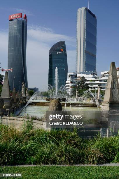 The three towers in CityLife district view from piazzale Giulio Cesare with the Quttro Stagioni fountain, Milan, Lombardy, Italy, Europe.